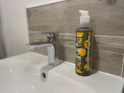 a bottle of toothpaste sitting on top of a sink at Hednes Barn in Crowan