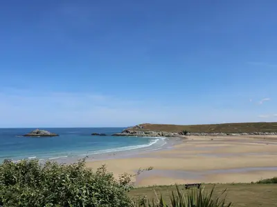 a sandy beach with the ocean in the background at Rosemaddon in Newquay