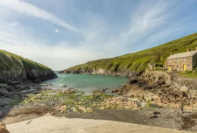 a house on a cliff next to a body of water at 3 Menague in Padstow