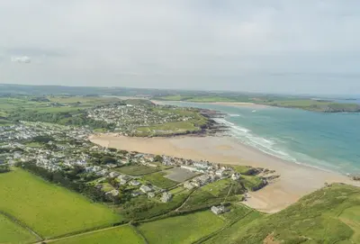 an aerial view of a beach with houses and the ocean at Highcroft in Saint Minver