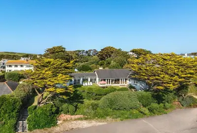 an aerial view of a house with trees and bushes at Rabbit Hill in Polzeath
