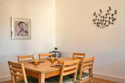 a dining room with a wooden table and chairs at Finest Retreats - Trippet Cottage at Bodmin Moor in Saint Breward