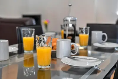 a table with two glasses of orange juice on it at Finest Retreats - Jubilee Cottage at Bodmin Moor in Saint Breward