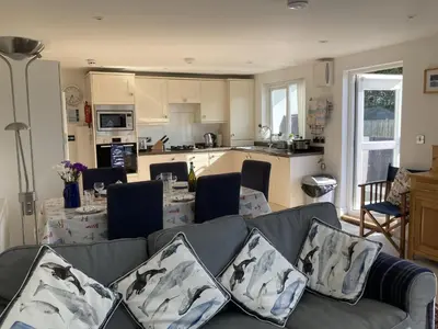 a living room with a couch and a kitchen at Flat 4, 10 Porthminster Terrace in St Ives