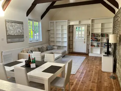 a living room with a table and a couch at Lovely cottage in Penryn centre with parking in Penryn