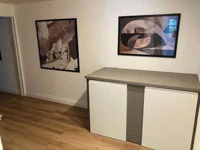a room with a counter with two pictures on the wall at Lovely cottage in Penryn centre with parking in Penryn