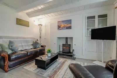 a living room with a leather couch and a fireplace at 2 Bed in Pensilva oc-z31812 in Middlehill