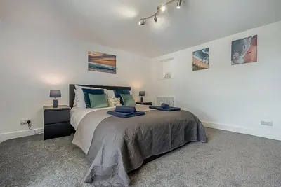 a bedroom with a bed and a nightstand with two lamps at 2 Bed in Pensilva oc-z31812 in Middlehill