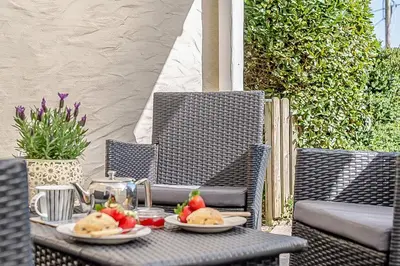a table with plates of food on top at 2 Bed in Pensilva oc-z31812 in Middlehill