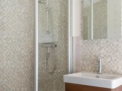 a bathroom with a shower and a sink at Sunshine Lodge in Polperro