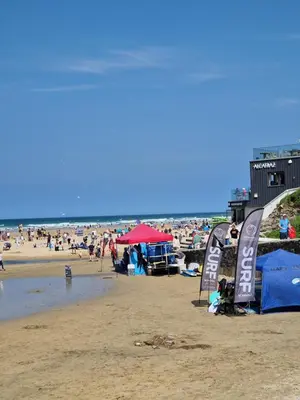 a beach with a lot of people on it at Dune Breeze-Haven Perran Sands Holiday Park in Perranporth