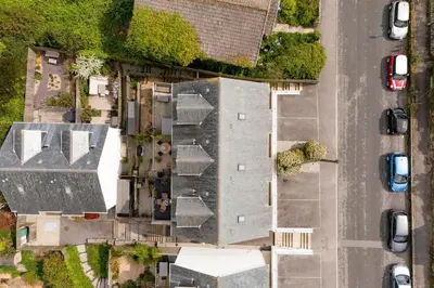 an overhead view of a house with a roof at Peaceful Harbour-View Cottage - Tresellick Gardens in Flushing