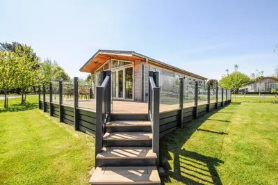 a tiny house with a staircase leading up to it at 17 Meadow Retreat in Liskeard