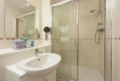 a bathroom with a sink and a glass shower at Puffin Way in Hayle