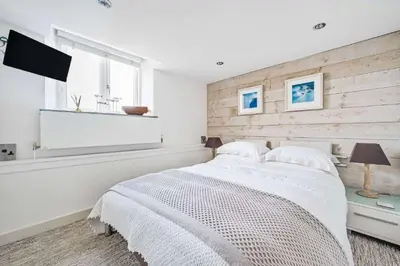 a bedroom with a white bed and a window at The Old Chapel in Saint Clement