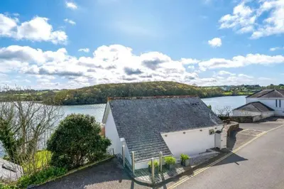 a house next to a body of water at The Old Chapel in Saint Clement