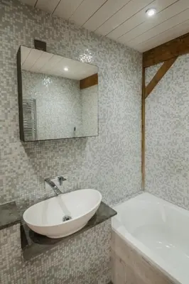 a bathroom with a sink and a tub and a mirror at 5 Star Large Farmhouse Near The Beach With Hot Tub & Sauna - Porth, Near Newquay in Saint Columb Minor