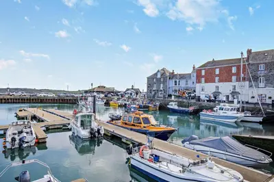 a group of boats are docked in a harbor at 2 Bed in Padstow oc-h29015 in Padstow