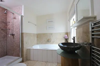 a bathroom with a bath tub and a sink at Cliff House in Padstow