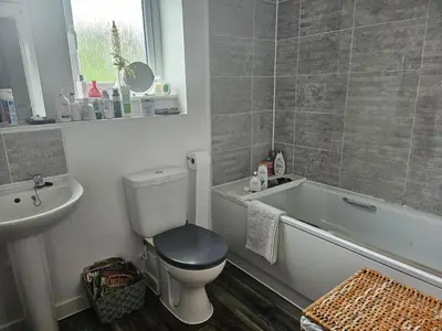 a bathroom with a toilet and a tub and a sink at House in Cornwall in Redruth