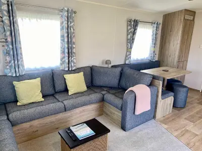 a living room with a blue couch and a table at The Bolt Hole Polperro in Polperro
