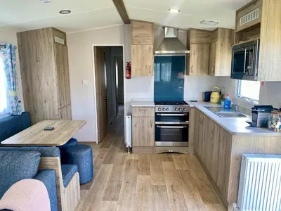 a small kitchen with a table and a stove at The Bolt Hole Polperro in Polperro
