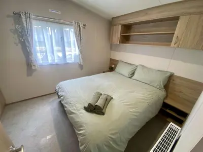 a bedroom with a bed with a pair of shoes on it at The Bolt Hole Polperro in Polperro