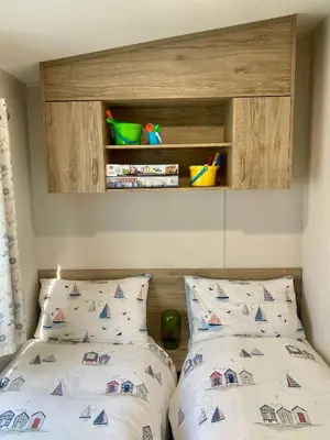 a bedroom with a bed with a headboard and two pillows at The Bolt Hole Polperro in Polperro