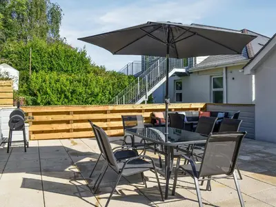 a table and chairs with an umbrella on a patio at 3 Le Dorney Villa - Uk49820 in Par