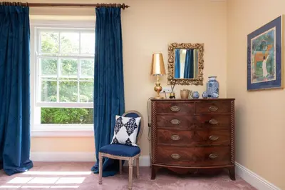 a bedroom with a dresser and a window at The Vicarage - Grand Country House, Walking Distance to Padstow and with Pub Across the Road in Wadebridge