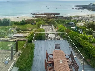 a view of the beach from a balcony of a house at Coastguards in Porthscatho
