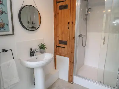 a bathroom with a sink and a shower at Candle Croft in Redruth