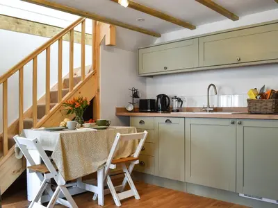 a kitchen with a table and a sink at Roseland Retreat - Uk49838 in Truro