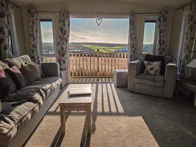 a living room with a couch and a table at Serenity in Truro
