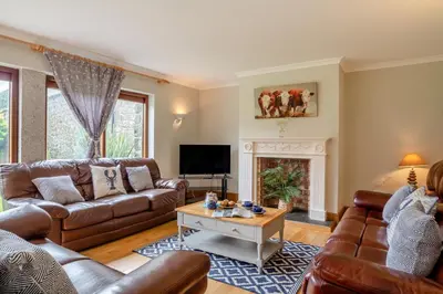 a living room with leather furniture and a fireplace at 3 Bed in St. Endellion oc-o30761 in Saint Endellion