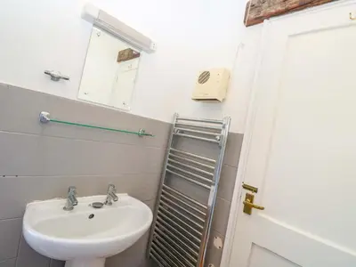 a bathroom with a sink and a mirror at The Shippen in Penzance