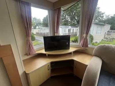 a computer desk in a room with a window at Pet Friendly Static in Carnbrea Station