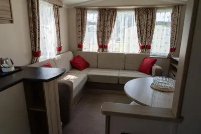 a living room with a couch and a table at Trevarth Holiday Park in Chacewater
