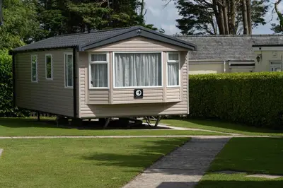 a small house is parked in a yard at Trevarth Holiday Park in Chacewater