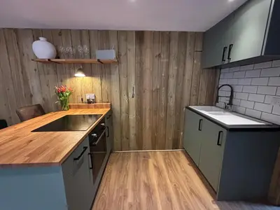a kitchen with a sink and a counter top at Cornish wooden cabin & wood fired hot tub in Gwennap