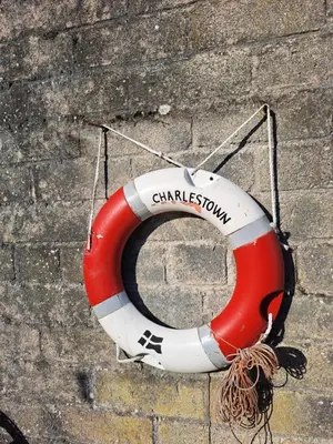 a red and white life buoy sitting on the ground at Bell Tent 1 in St Austell