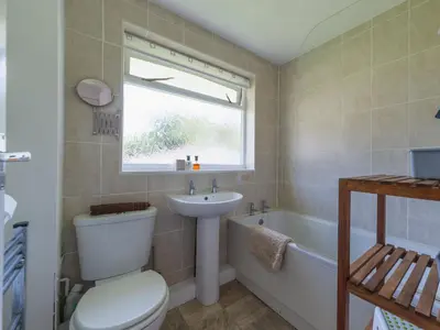 a bathroom with a toilet and a sink and a tub at Chalet Bliss by Interhome in Liskeard