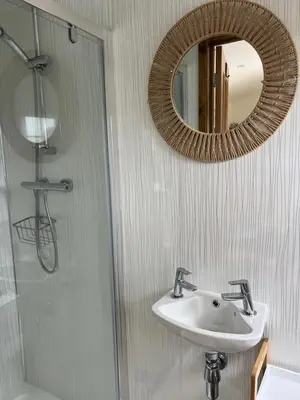a bathroom with a sink and a mirror at Morthana Shepherd Hut in Scorrier