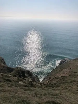 a view of the ocean from the top of a hill at SeaNest, Aggie Home by the sea in St. Agnes