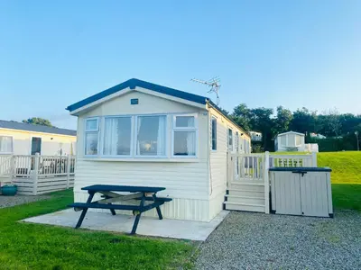 a tiny house with a picnic table next to it at Calm View in St Austell