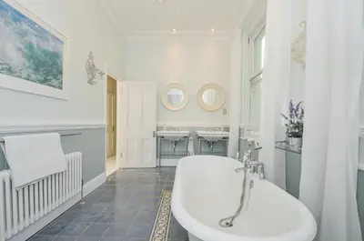 a white bathroom with a tub and a sink at Trenare in Truro
