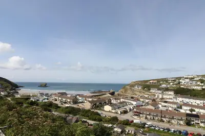 an aerial view of a town next to the ocean at Carn Brea in Redruth
