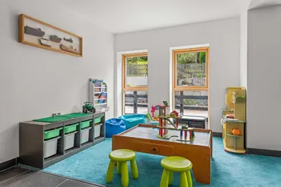a room with a table and two stools at House 21 in Looe