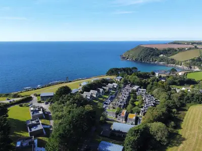 an aerial view of a resort next to the ocean at House 21 in Looe