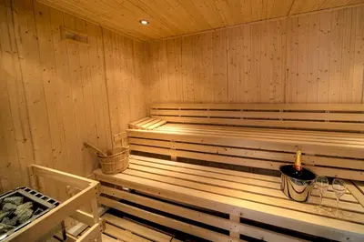 a wooden sauna with a bucket in it at House 2 in Looe